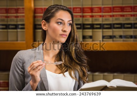 Pretty lawyer reading in the law library at the university