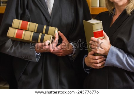 Lawyers holding books in the law library at the university