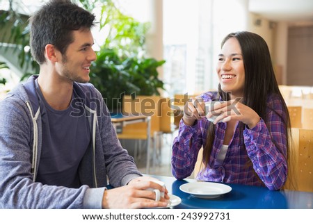 Young students having coffee together at the university