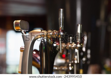 Beer pumps in a row in a bar