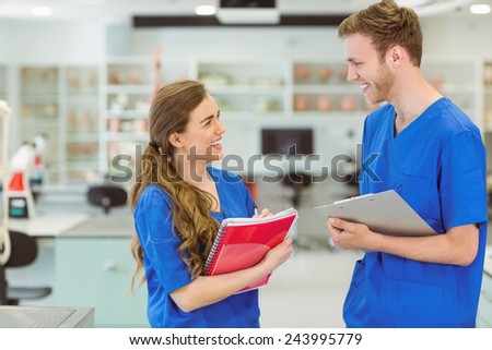 Young medical students smiling at each other at the university