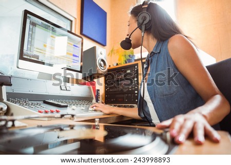 Portrait of an university student mixing audio in a studio of a radio