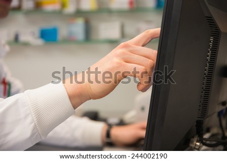 Pharmacist using the computer at the hospital pharmacy