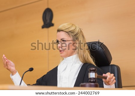 Stern judge speaking to the court in the court room