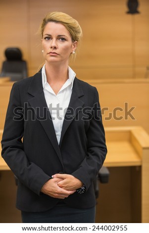 Serious lawyer looking at camera in the court room