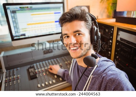 Portrait of an university student mixing audio in a studio of a radio