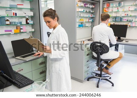 Team of pharmacists working on computers at the hospital pharmacy