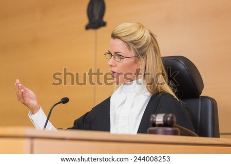 Stern judge speaking to the court in the court room