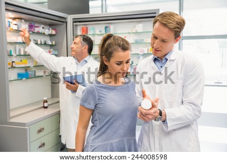 Happy customer talking with pharmacist at the hospital pharmacy