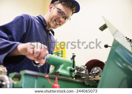 Engineering student using heavy machinery at the university