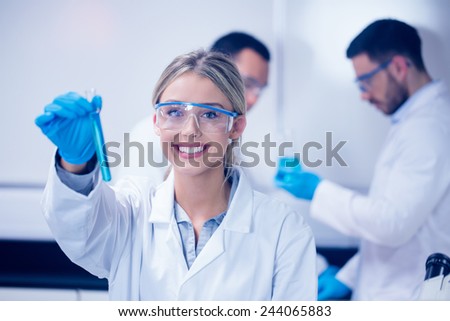 Science student holding up test tube at the university