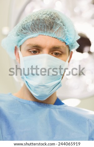 Young surgeon wearing mask and cap at the university