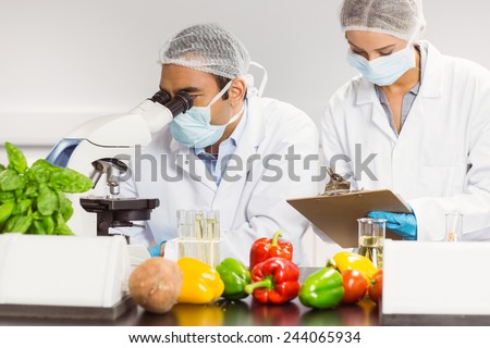 Food scientists using the microscope for research at the university