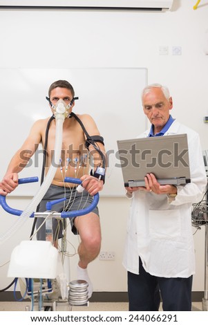 Man doing fitness test on exercise bike at the medical centre