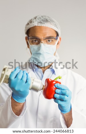 Food scientist using device on pepper at the university