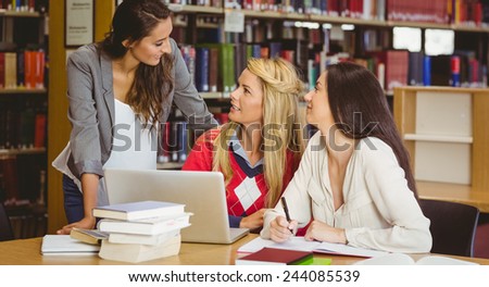 Happy three students working together in library
