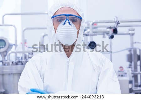 Portrait of a scientist standing with arms crossed in the factory