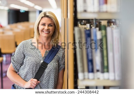 Mature student studying in the library with tablet at the university