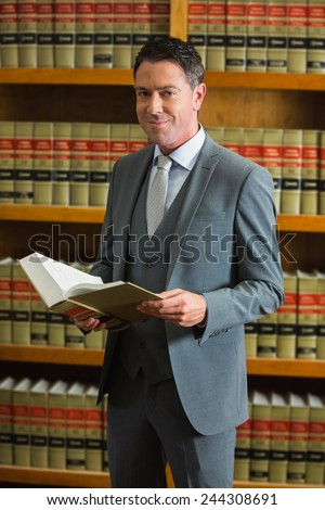 Lawyer holding book in the law library at the university