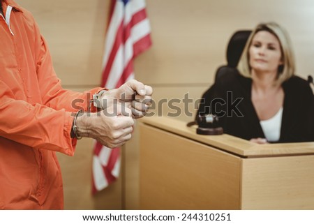 Close up of a prisoner wearing handcuffs in the court room