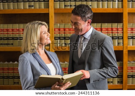 Lawyers reading book in the law library at the university