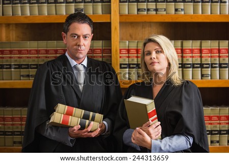 Lawyers holding books in the law library at the university