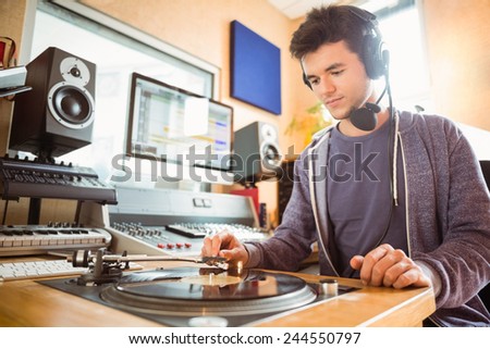 Portrait of an university student with a turn table in the studio of a radio