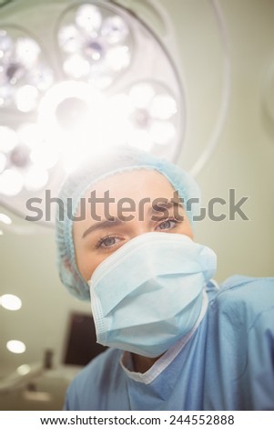 Young surgeon looking down at camera at the university