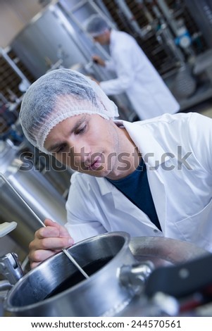 Close up of a man wearing a hair net in the factory
