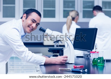 Science student working with microscope in the lab at the university