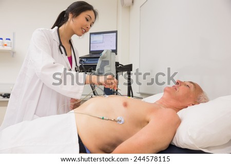 Medical student practicing on older man at the university