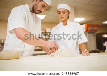Team of bakers preparing dough in a commercial kitchen