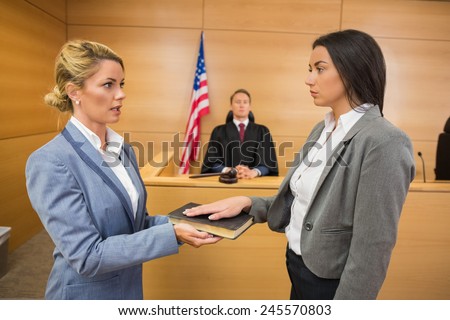 Witness taking an oath in the court room