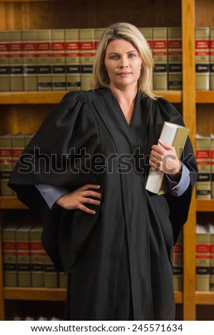 Lawyer holding book in the law library at the university