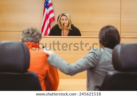 Judge and lawyer discussing the sentence for prisoner in the court room
