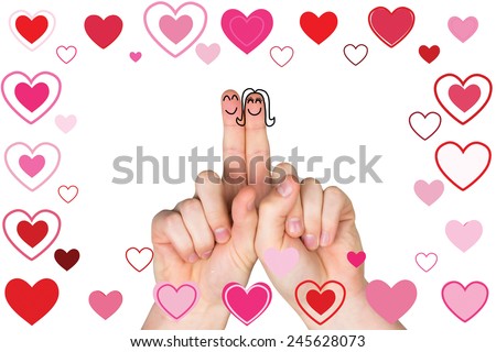 Fingers crossed like a couple against valentines heart design