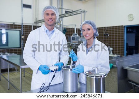 Portrait of smiling scientist team in the factory
