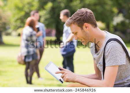 Handsome student studying outside on campus at the university