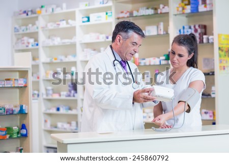 Pharmacist showing patient her blood pressure reading in the pharmacy