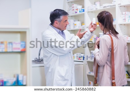Pharmacist explaining medicine to patient in the pharmacy