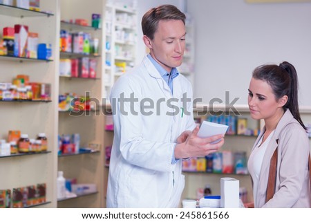 Pharmacist explaining the drug to patient in the pharmacy