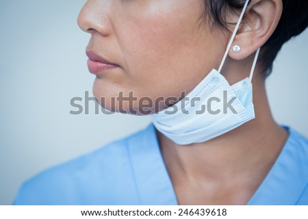 Close up mid section of female dentist wearing surgical mask