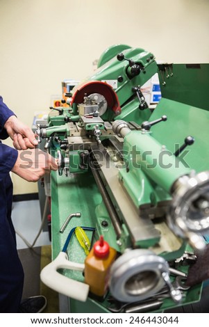 Engineering student using heavy machinery at the university