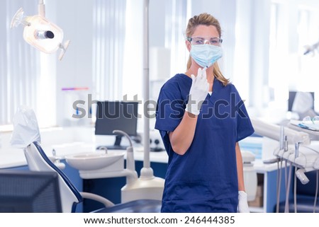 Dentist in mask and glove holding an injection at the dental clinic