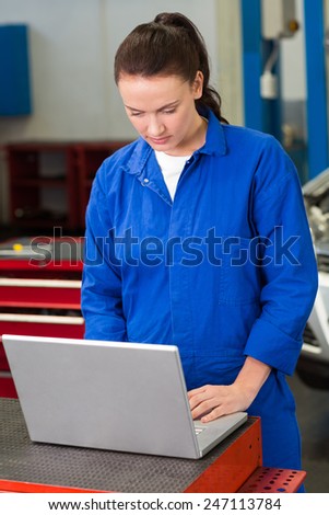 Mechanic working on a laptop at the repair garage
