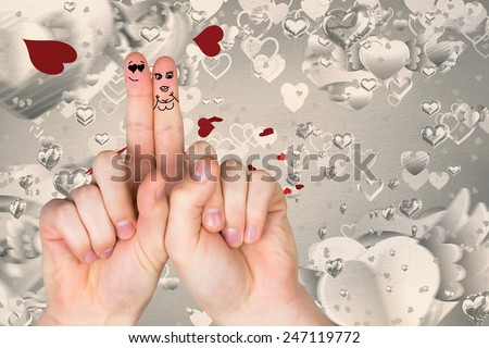 Fingers crossed like a couple against love heart pattern