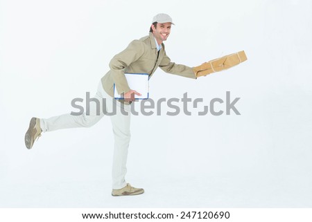 Full length side view of happy delivery man with parcel running against white background