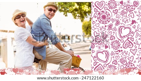 Happy mature couple going for a bike ride in the city against valentines pattern