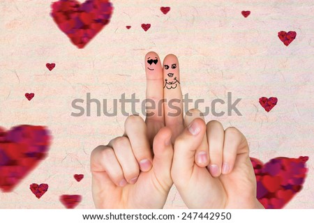 Fingers crossed like a couple against love heart pattern