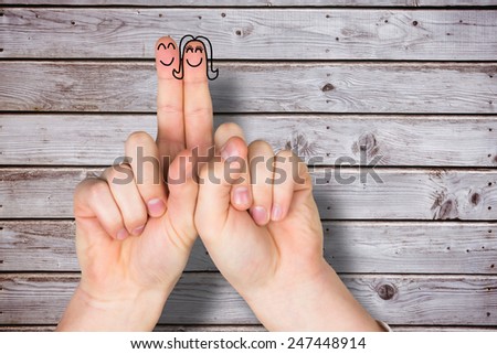 Fingers crossed like a couple against digitally generated grey wooden planks